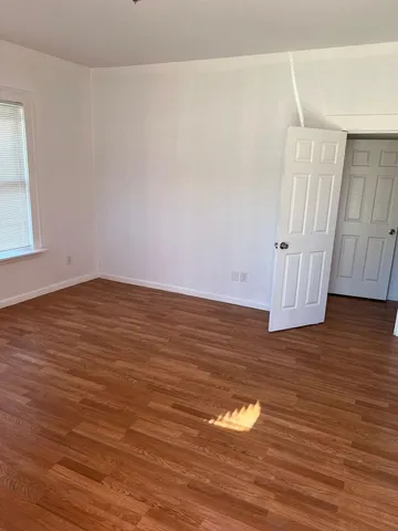 a view of room with wooden floor and window