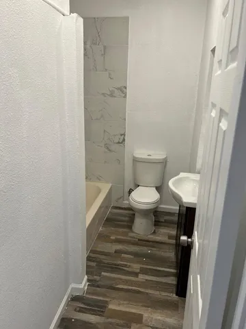 a bathroom with a toilet and a shower