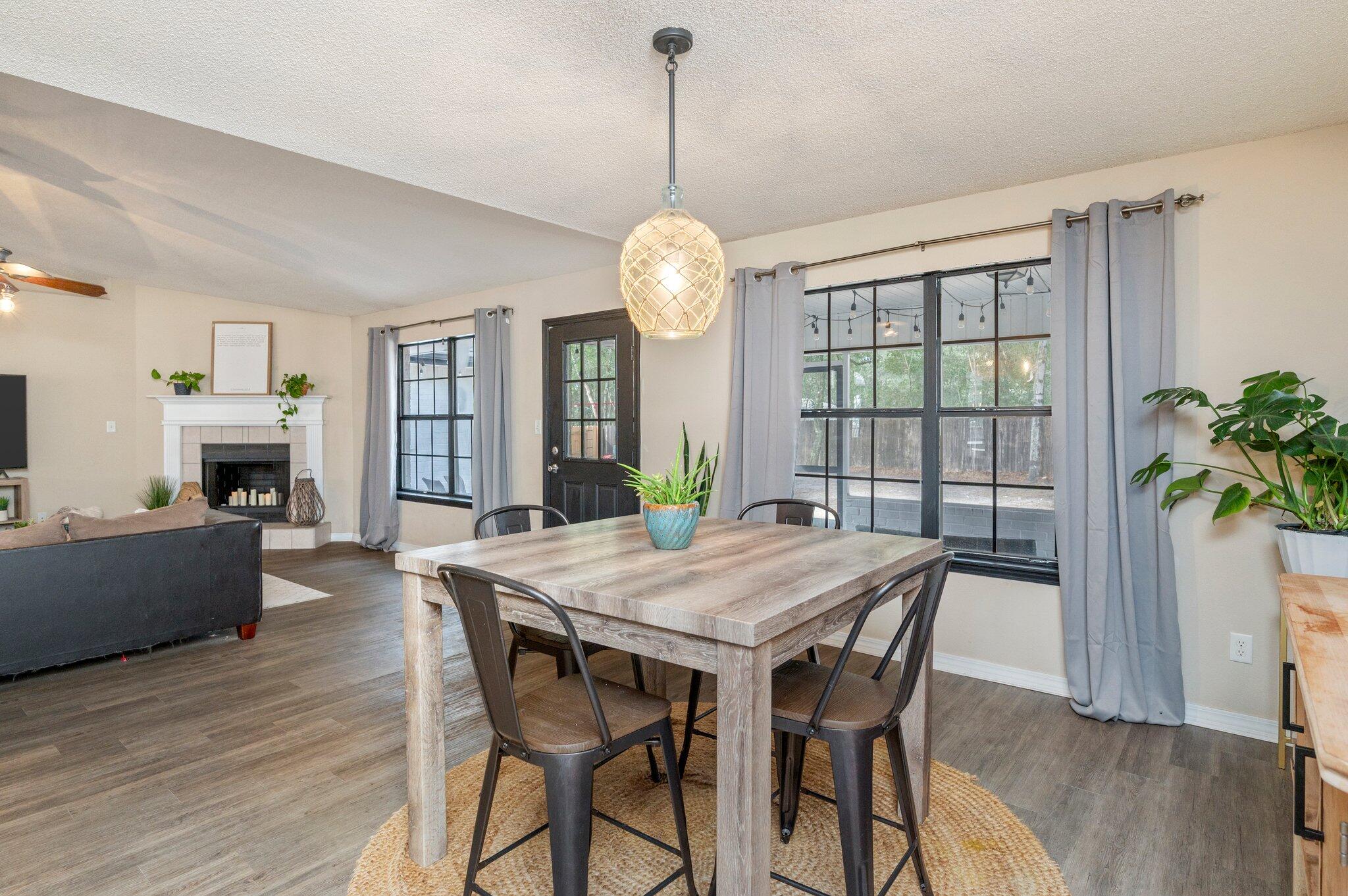 5938 Ridgeview Drive Milton, FL 32570 - Photo 20 of 58 a view of a dining room with furniture window and wooden floor