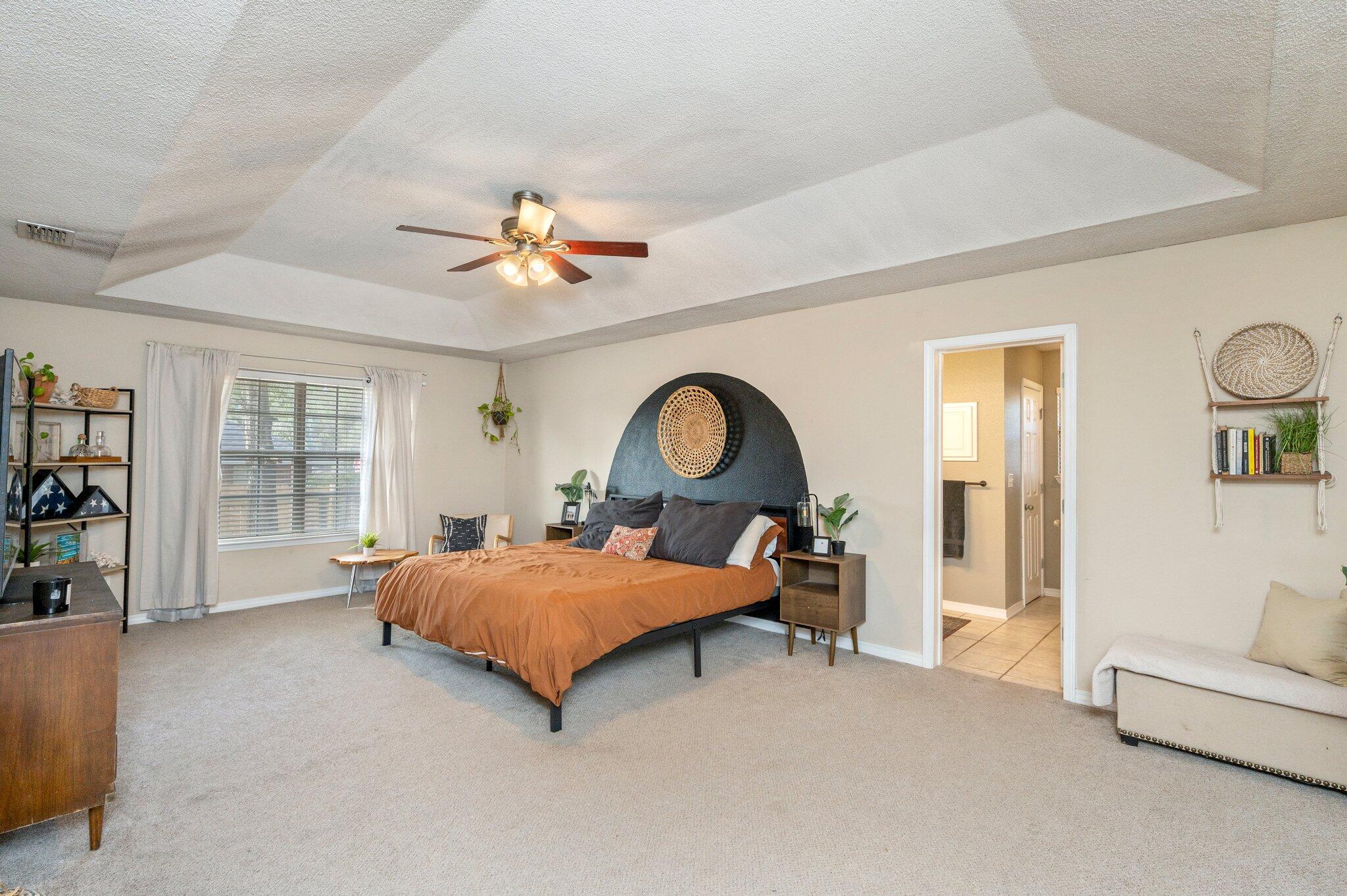 5938 Ridgeview Drive Milton, FL 32570 - Photo 27 of 58 a bedroom with a bed and a chandelier