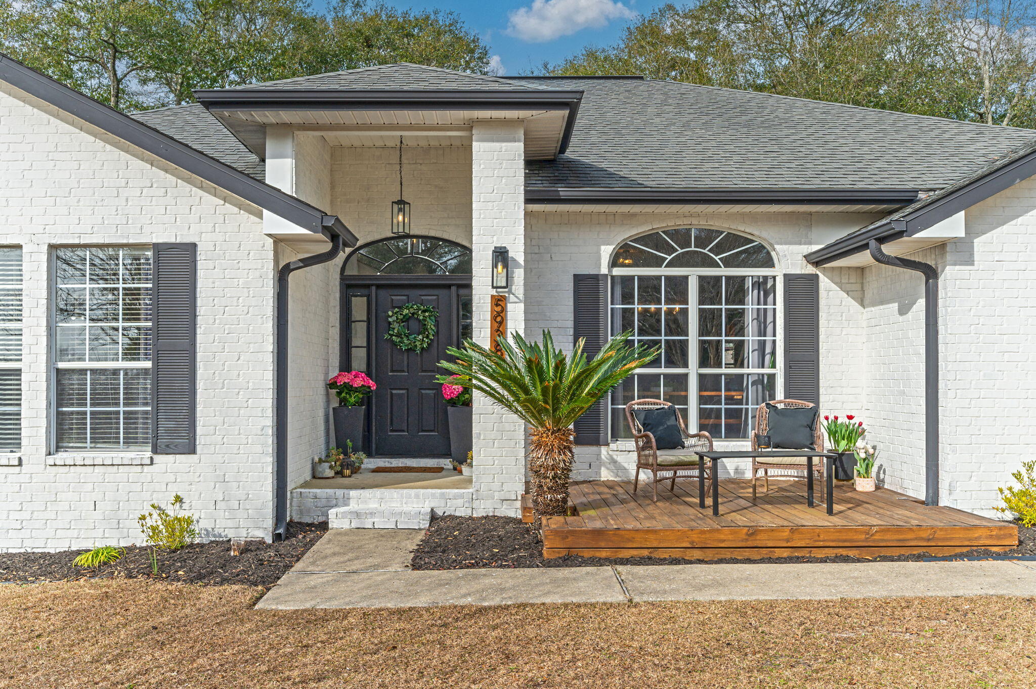 5938 Ridgeview Drive Milton, FL 32570 - Photo 3 of 58 a front view of a house with garden