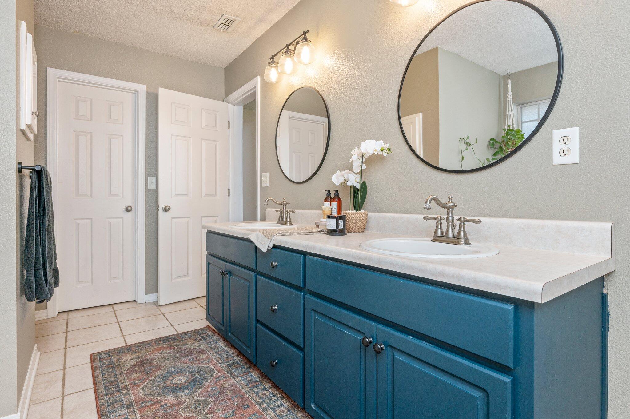 5938 Ridgeview Drive Milton, FL 32570 - Photo 31 of 58 a bathroom with a double vanity sink and a mirror