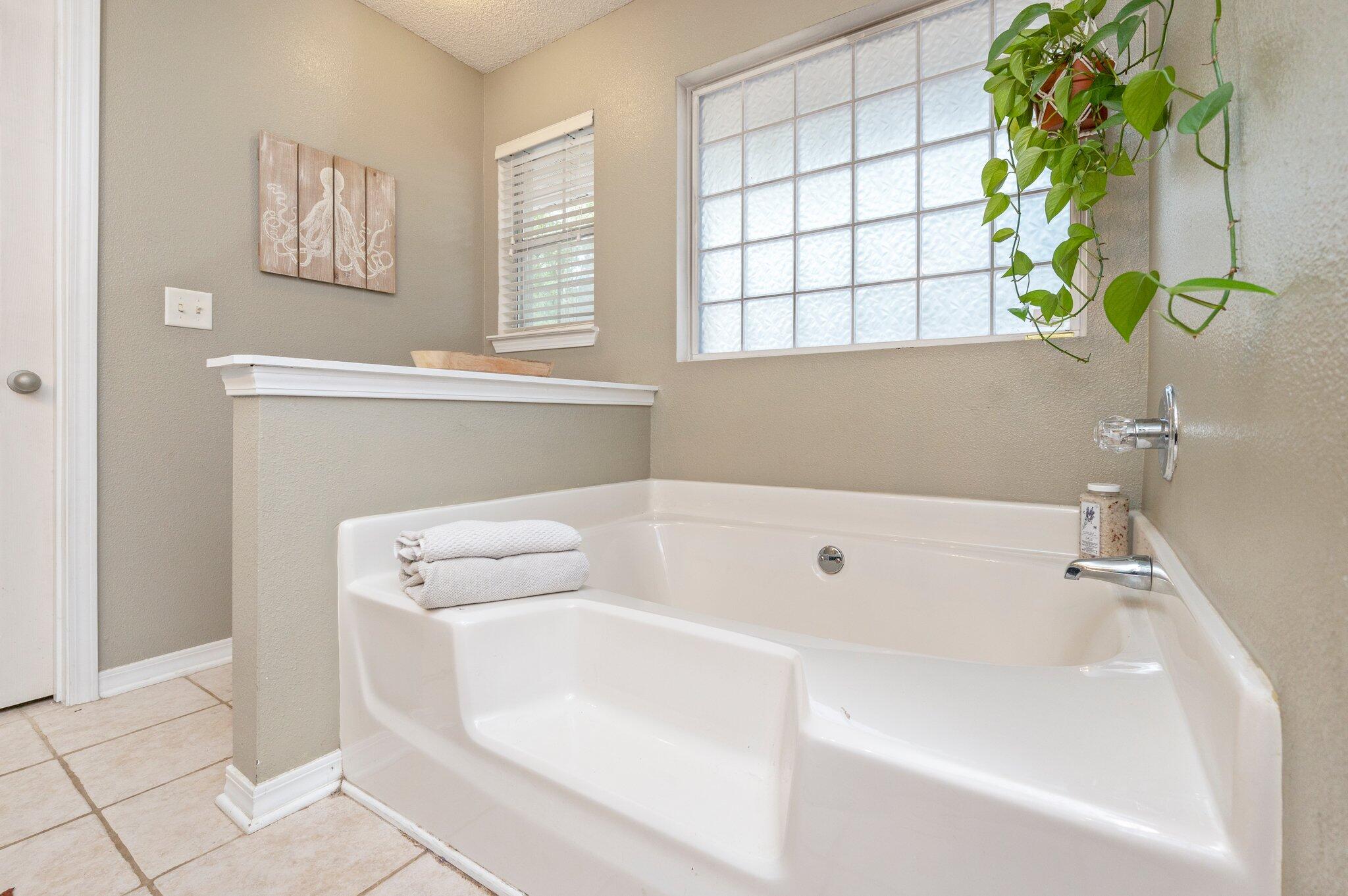 5938 Ridgeview Drive Milton, FL 32570 - Photo 32 of 58 a bath tub sitting in a bathroom next to a window