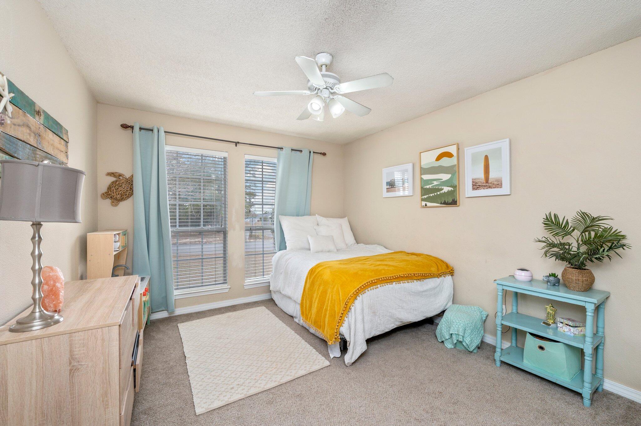 5938 Ridgeview Drive Milton, FL 32570 - Photo 36 of 58 a bedroom with a bed and a chandelier