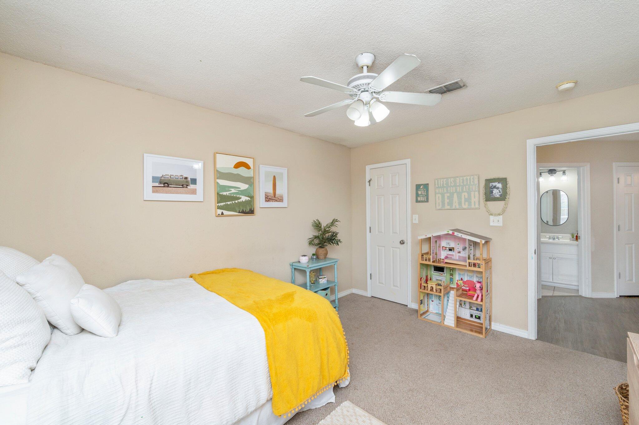 5938 Ridgeview Drive Milton, FL 32570 - Photo 37 of 58 a bedroom with a bed and a chandelier