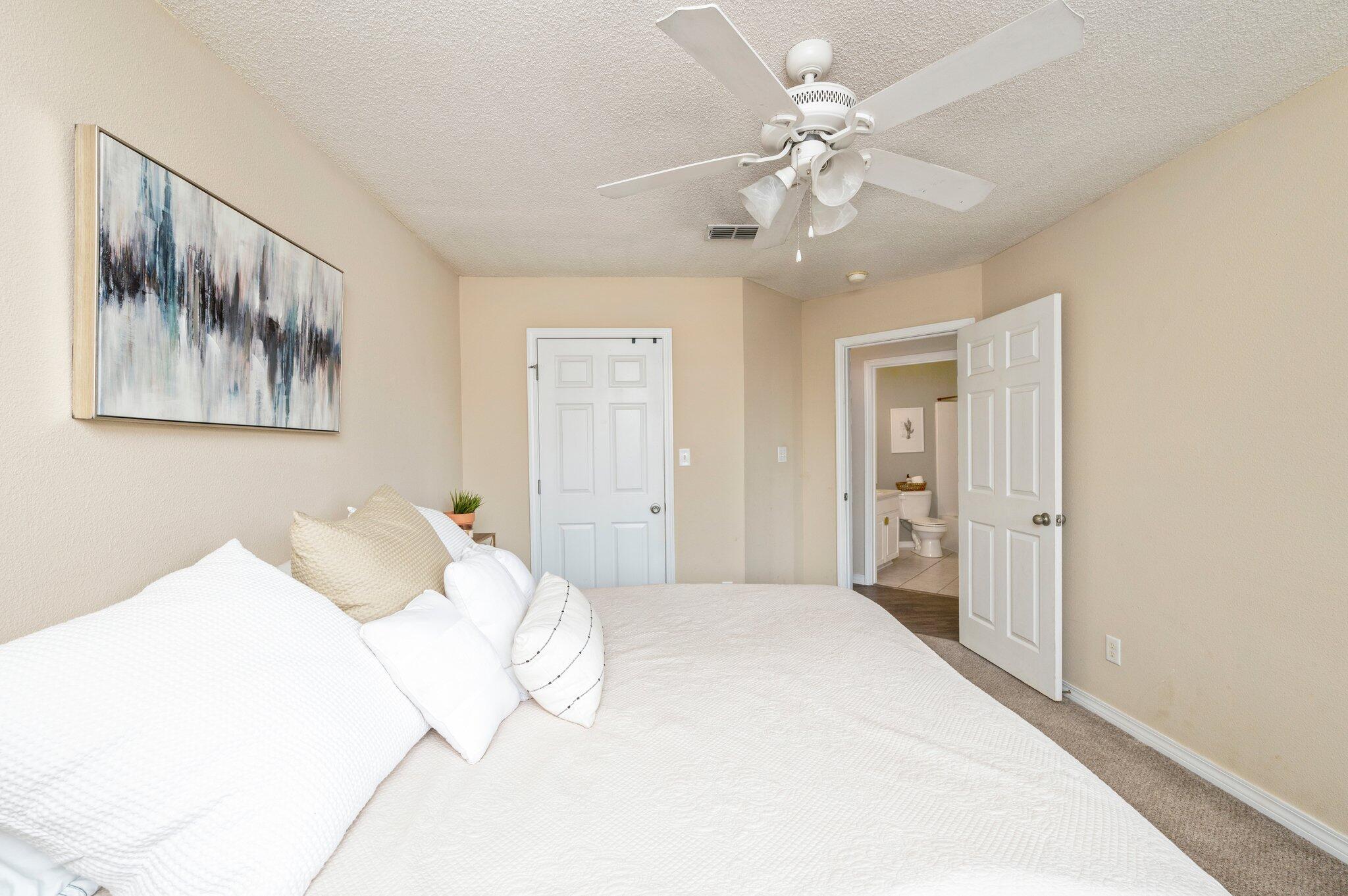 5938 Ridgeview Drive Milton, FL 32570 - Photo 38 of 58 a bedroom with a large bed and a chandelier
