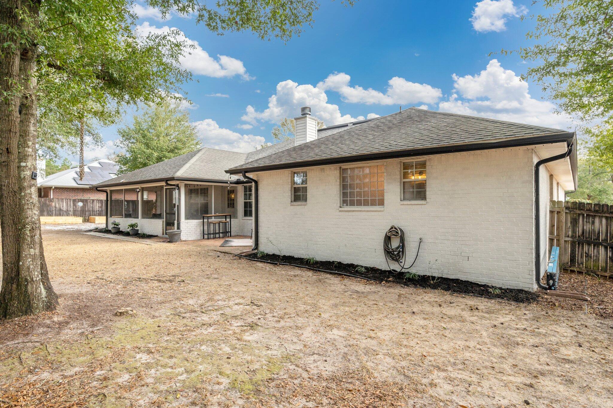 5938 Ridgeview Drive Milton, FL 32570 - Photo 48 of 58 a front view of a house with a yard and garage