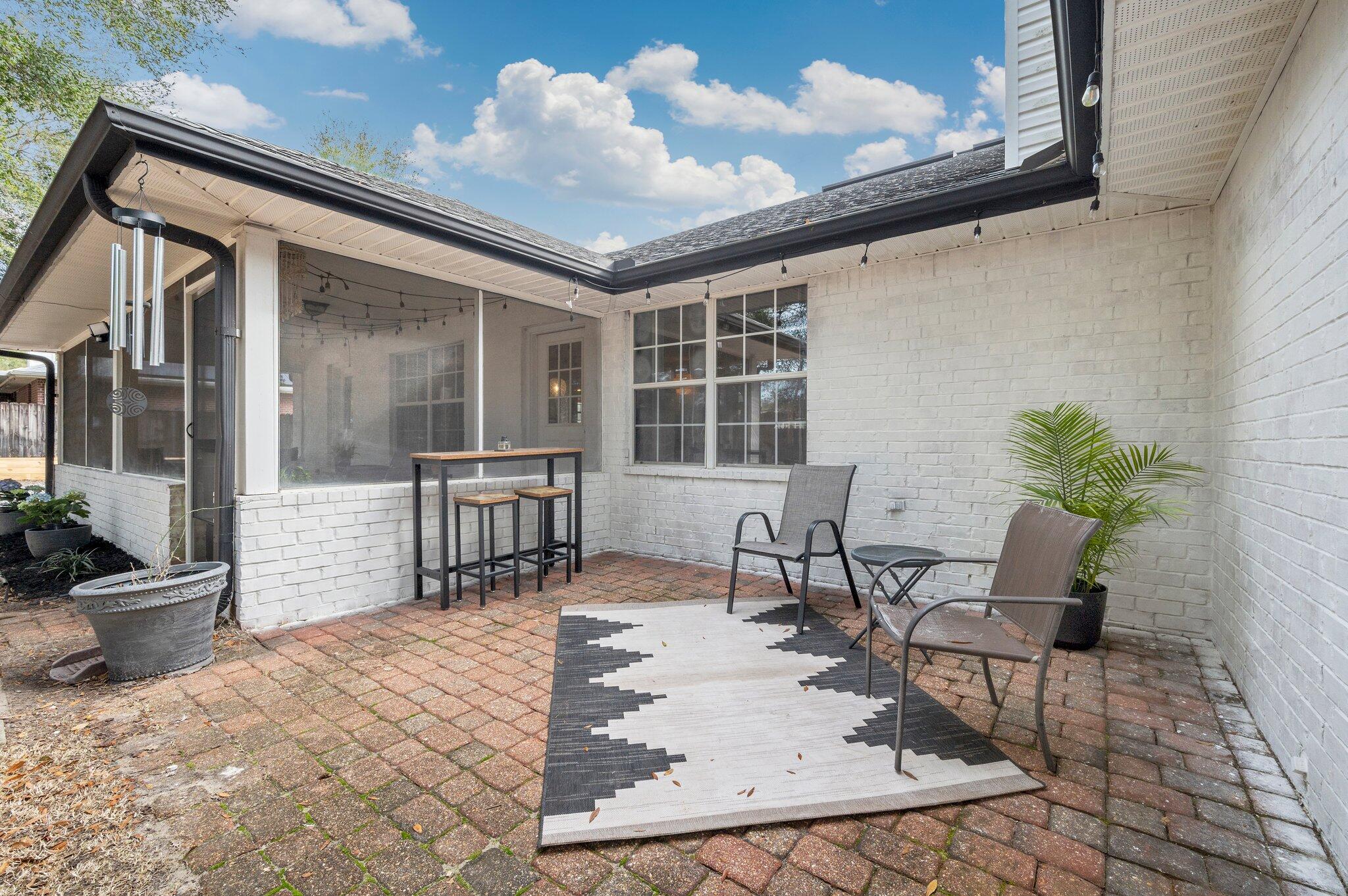 5938 Ridgeview Drive Milton, FL 32570 - Photo 52 of 58 a building outdoor space with patio furniture and potted plants