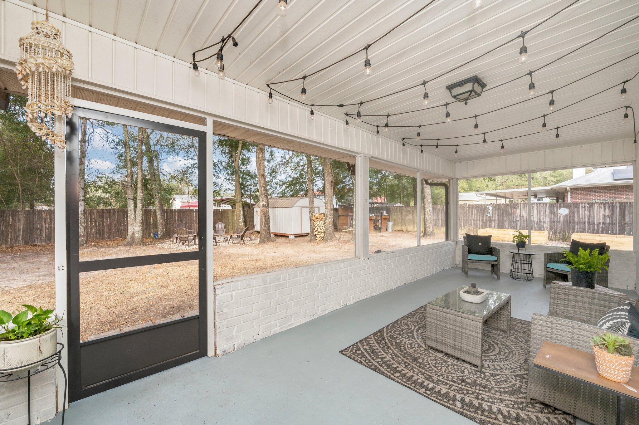 5938 Ridgeview Drive Milton, FL 32570 - Photo 54 of 58 a living room with lots of furniture wooden floor and a large window
