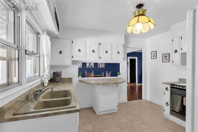 a kitchen that has a lot of cabinets and appliances
