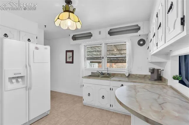 a bathroom with a granite countertop sink a mirror a vanity and a shower