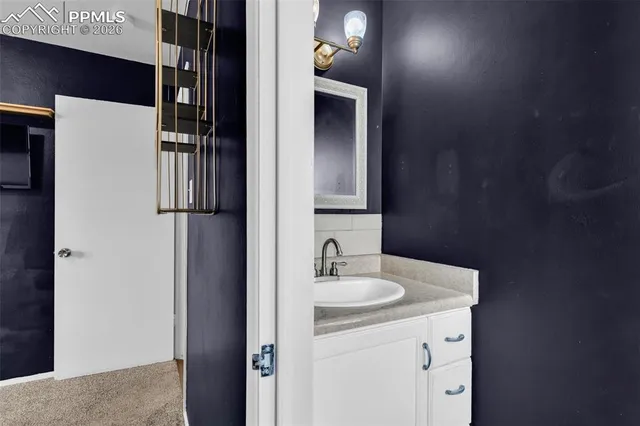 a bathroom with a sink toilet and mirror