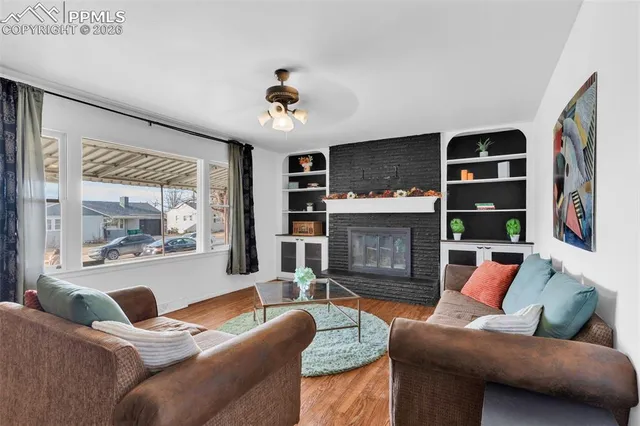a living room with furniture and a fireplace