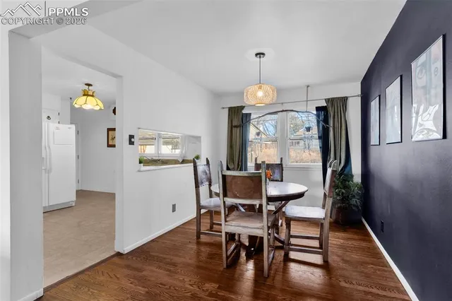 a view of a dining room with furniture and wooden floor