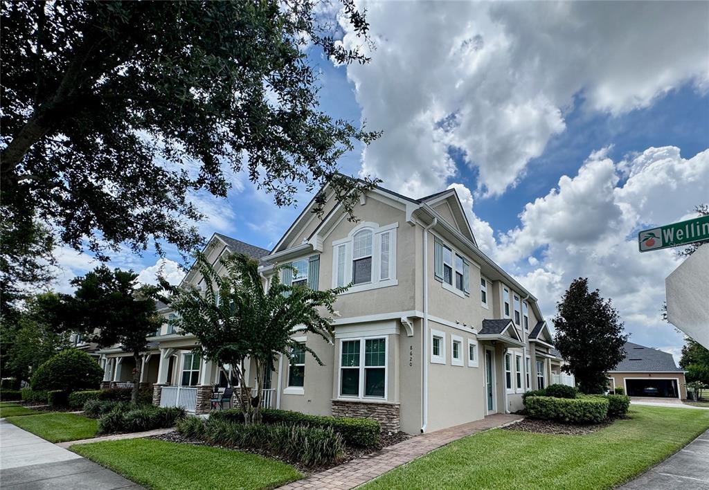 8620 Wellington Blue Lane Windermere, FL 34786 - Photo 1 of 22 a front view of a house with a garden