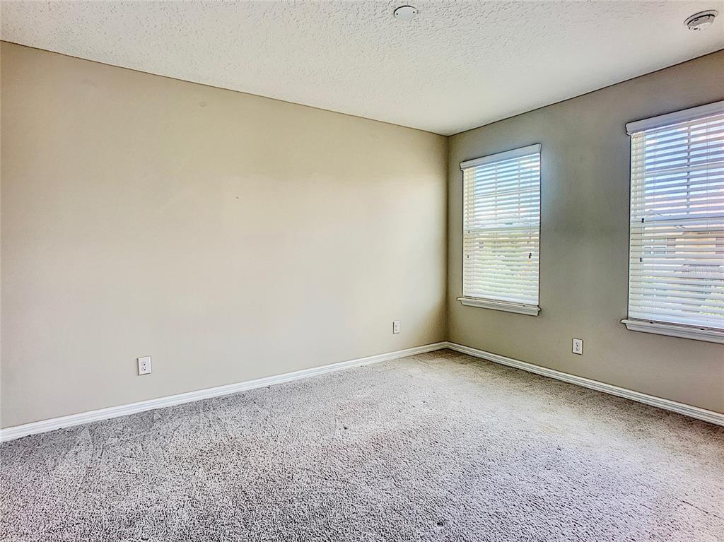 8620 Wellington Blue Lane Windermere, FL 34786 - Photo 20 of 22 an empty room with a empty space and windows