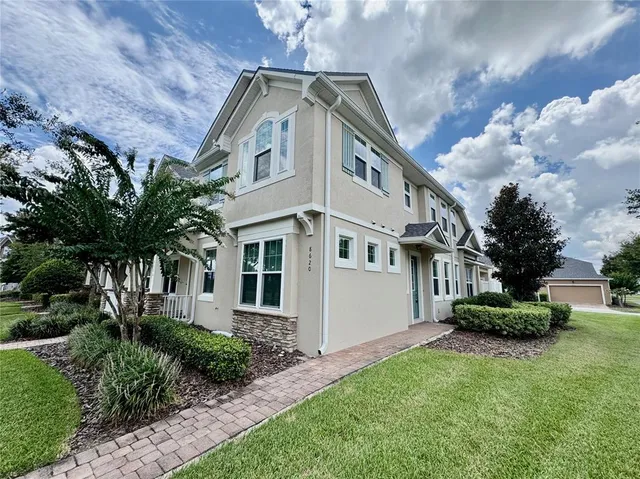 a front view of a house with a garden
