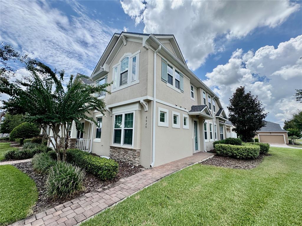 8620 Wellington Blue Lane Windermere, FL 34786 - Photo 2 of 22 a front view of a house with a garden