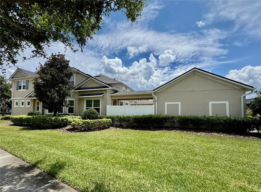 8620 Wellington Blue Lane Windermere, FL 34786 - Photo 3 of 22 a view of house with yard and green space