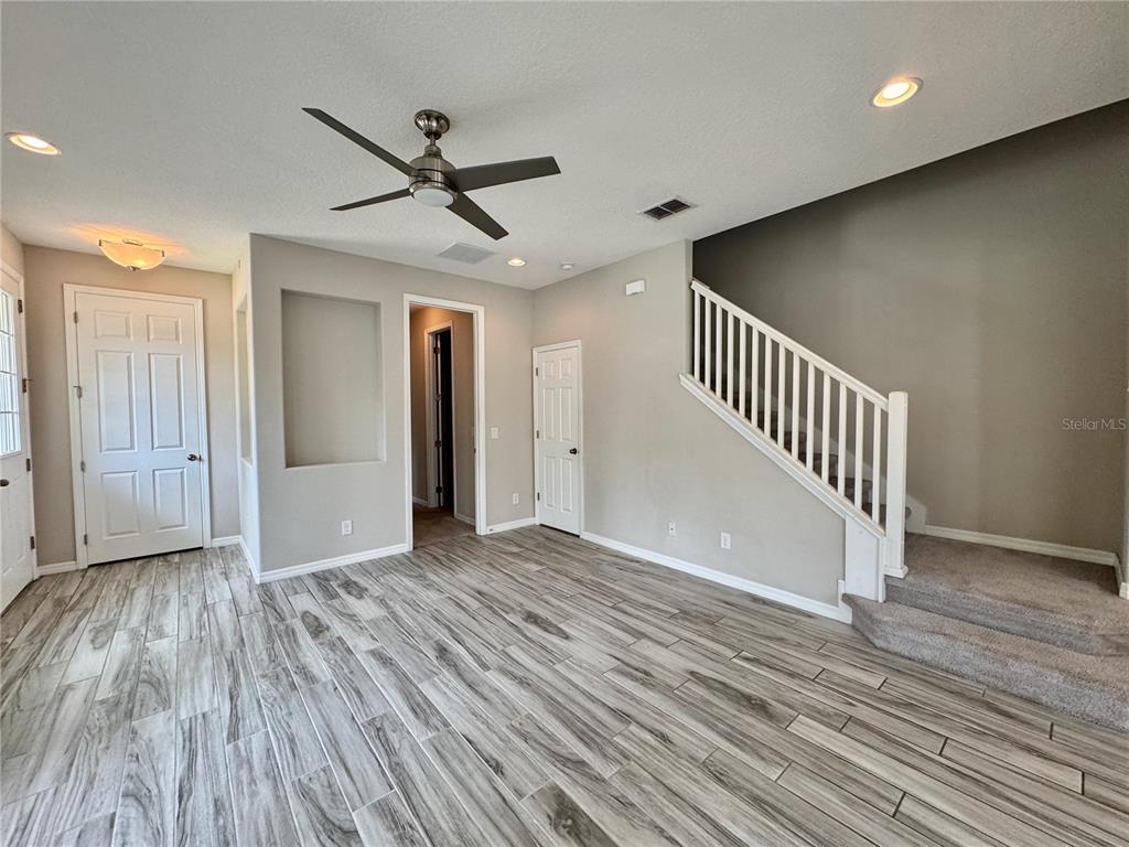 8620 Wellington Blue Lane Windermere, FL 34786 - Photo 4 of 22 wooden floor in an empty room with a window