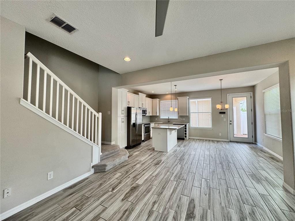 8620 Wellington Blue Lane Windermere, FL 34786 - Photo 6 of 22 a view of a livingroom with wooden floor and electronic appliances