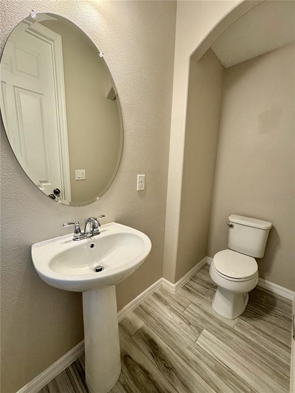 8620 Wellington Blue Lane Windermere, FL 34786 - Photo 9 of 22 a bathroom with a sink toilet and mirror