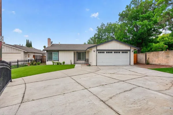 a front view of a house with a yard and a garage