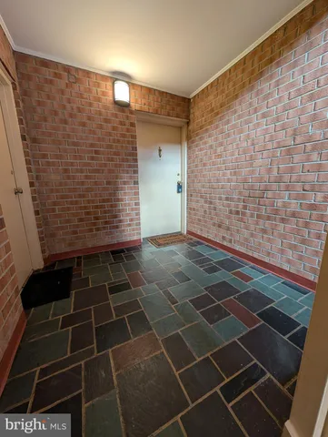 a view of an empty room and wooden floor