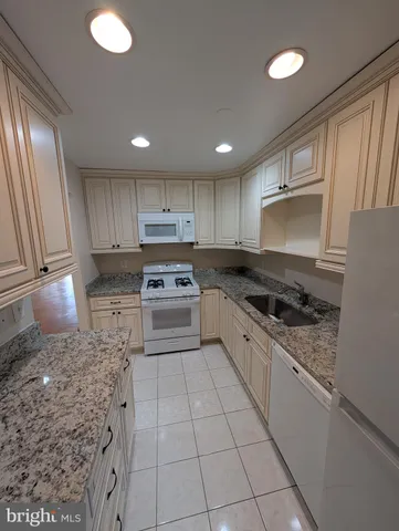 a kitchen with a sink stainless steel appliances and cabinets