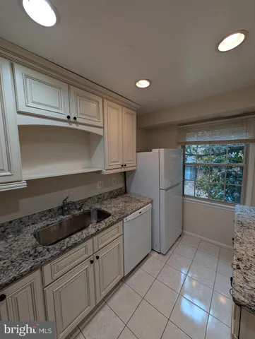 a kitchen with a stove and a refrigerator