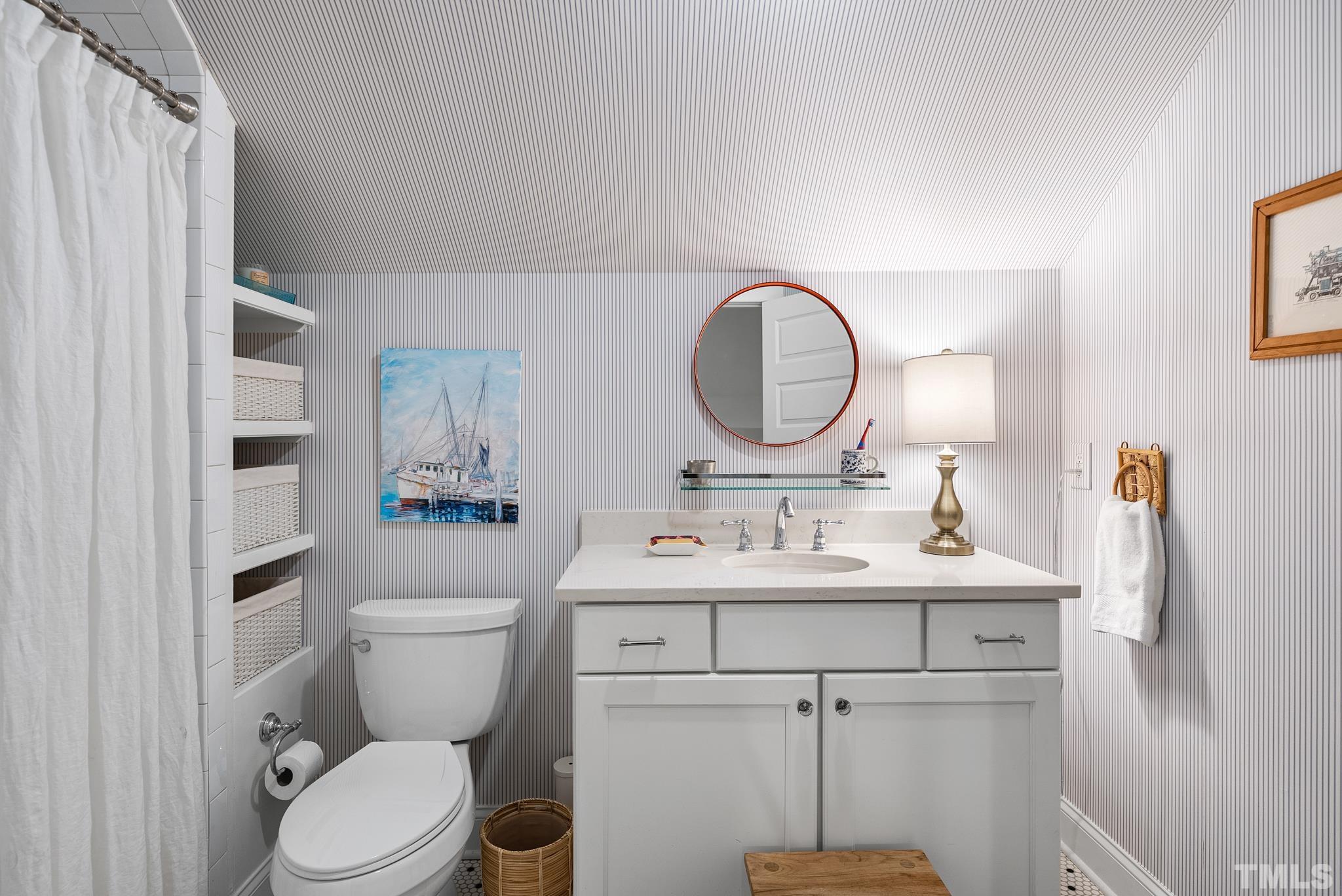 1841 Reaves Drive Raleigh, NC 27608 - Photo 16 of 25 a bathroom with a toilet sink and mirror