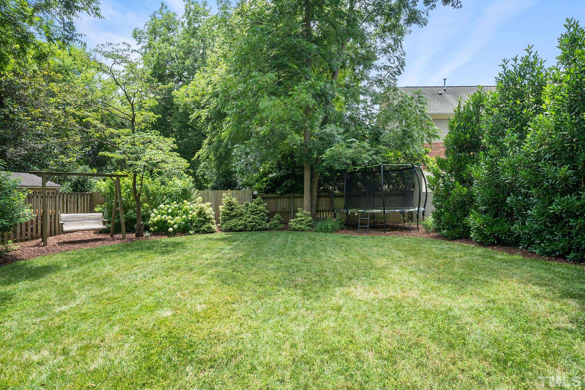 1841 Reaves Drive Raleigh, NC 27608 - Photo 24 of 25 a view of a backyard with large trees