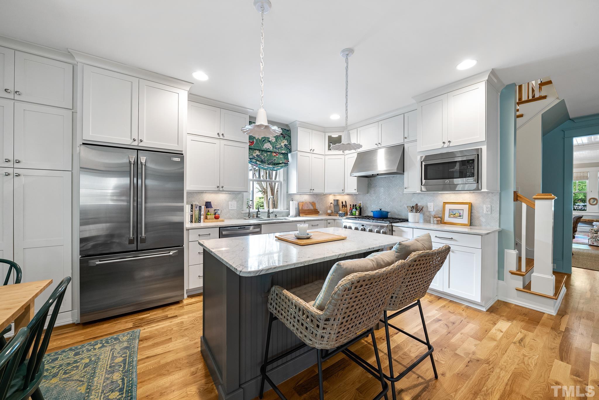 1841 Reaves Drive Raleigh, NC 27608 - Photo 7 of 25 a kitchen with stainless steel appliances granite countertop a refrigerator a stove top oven a sink dishwasher and a refrigerator