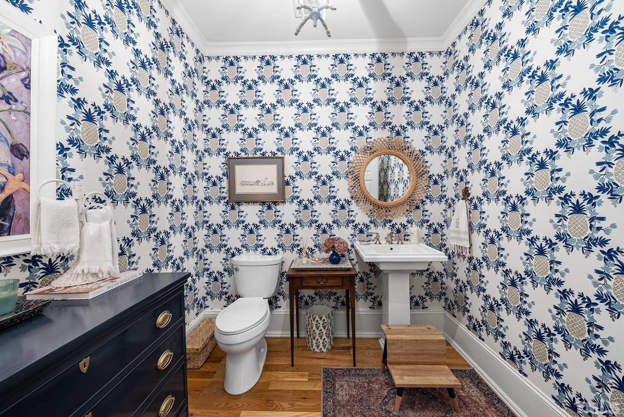 1841 Reaves Drive Raleigh, NC 27608 - Photo 10 of 25 a bathroom with a sink a toilet and a mirror