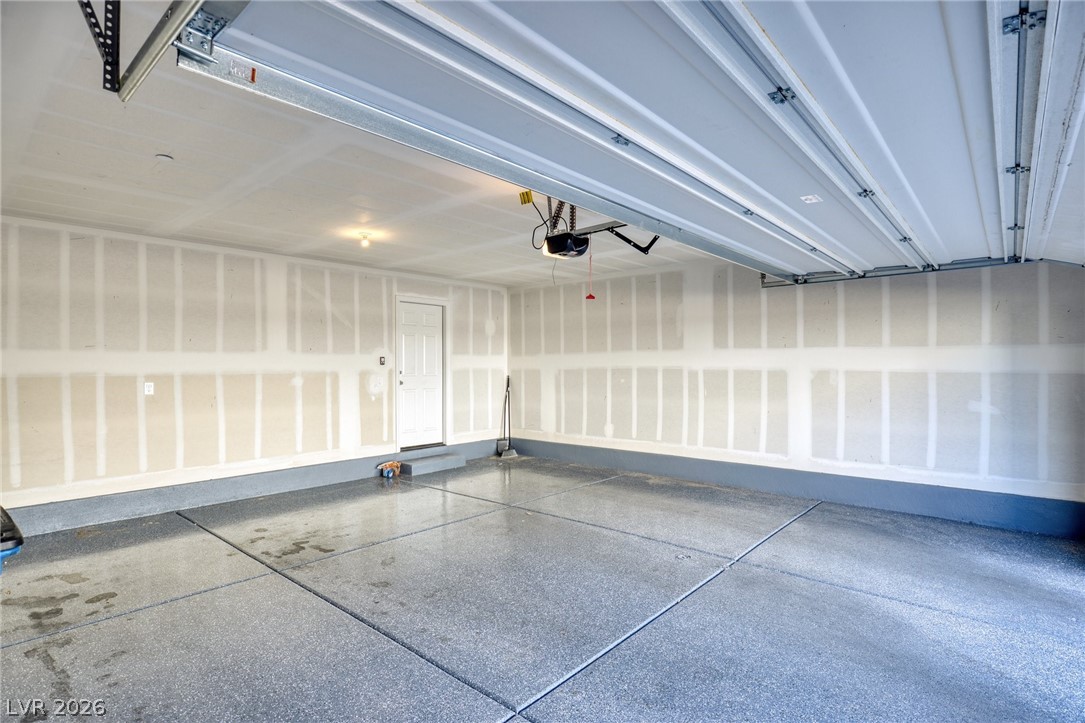6227 Runestone Street Las Vegas, NV 89113 - Photo 31 of 33 This spacious garage offers ample storage and features a durable epoxy-coated floor.