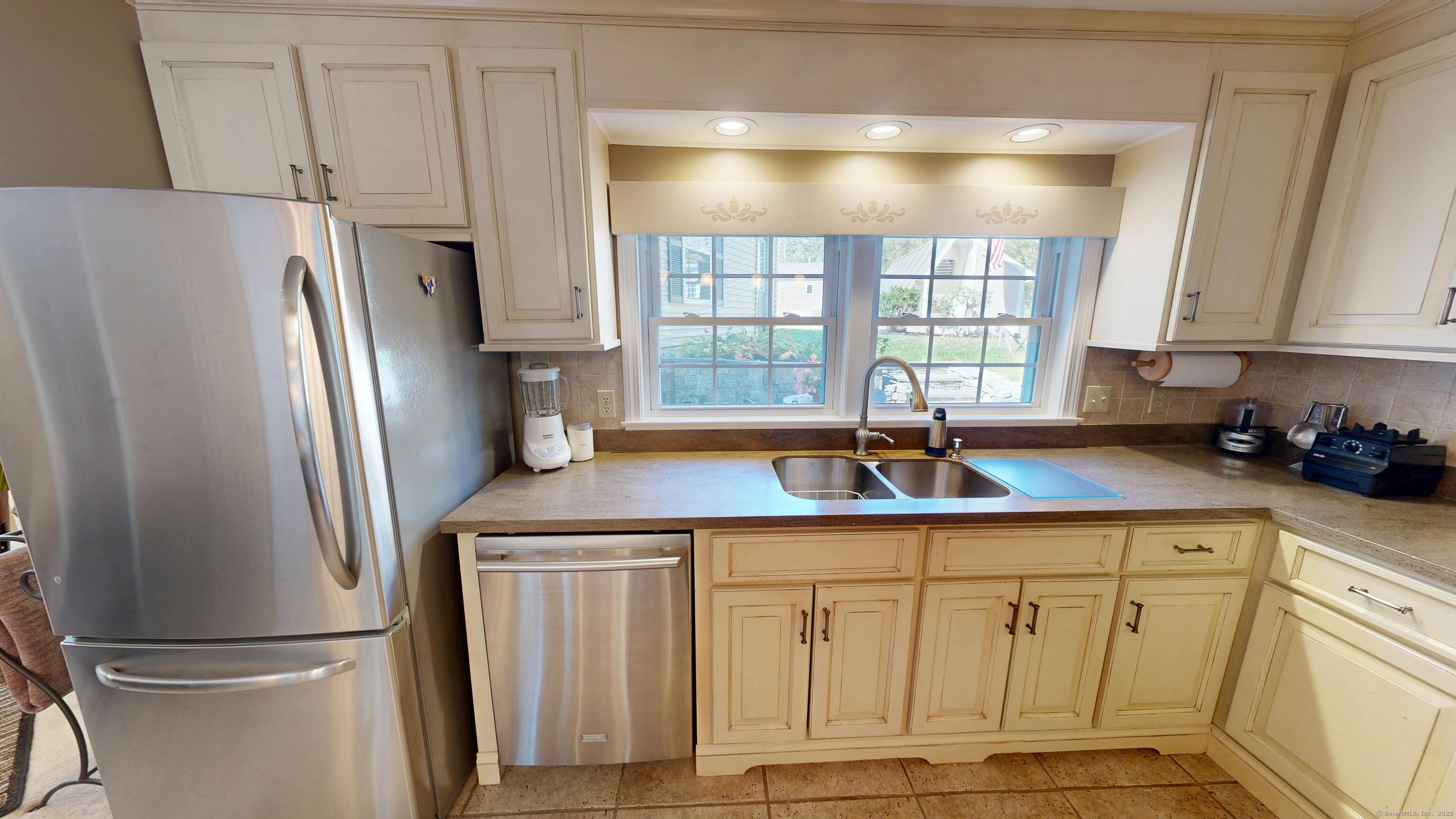 214 Mountain Road Cheshire, CT 06410 - Photo 11 of 40 a kitchen with stainless steel appliances granite countertop a refrigerator a sink and white cabinets