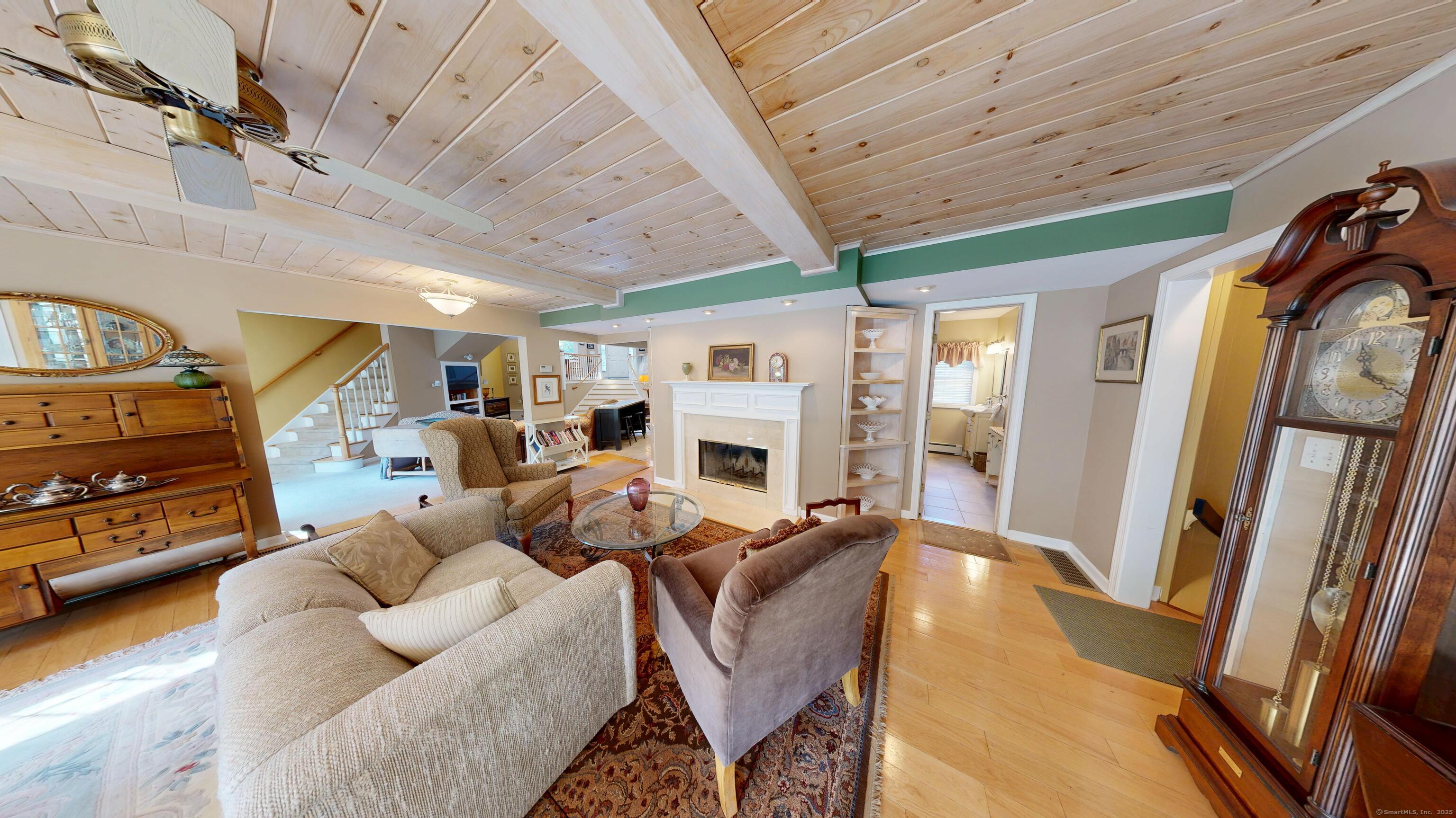 214 Mountain Road Cheshire, CT 06410 - Photo 15 of 40 a living room with furniture a fireplace and a flat screen tv