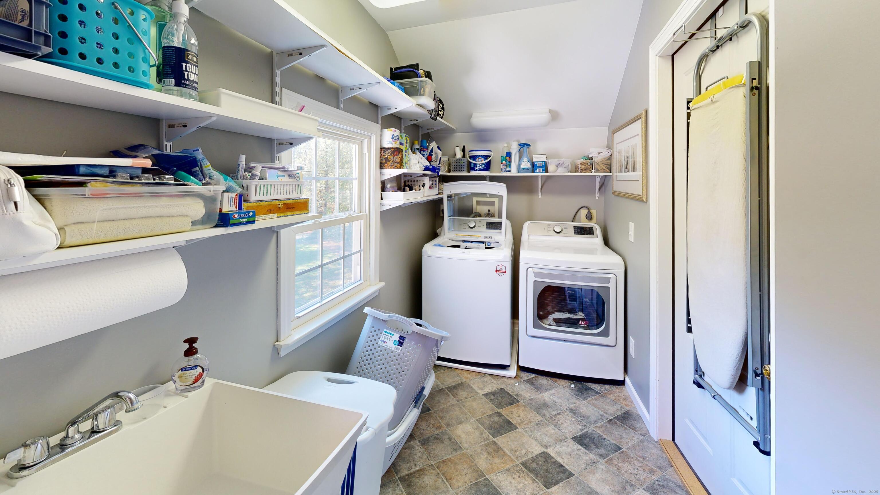 214 Mountain Road Cheshire, CT 06410 - Photo 21 of 40 a utility room with cabinets dryer and washer