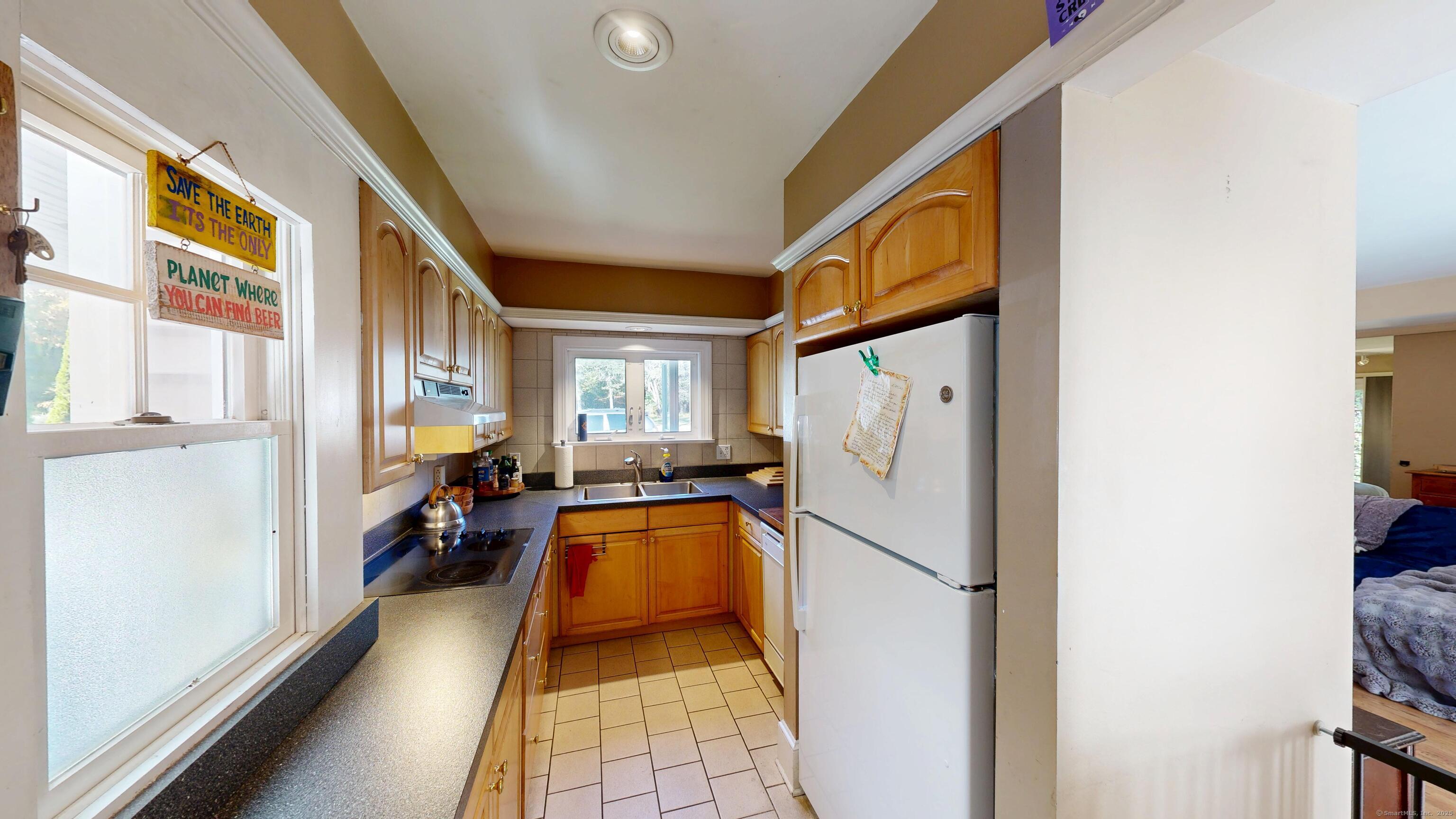 214 Mountain Road Cheshire, CT 06410 - Photo 35 of 40 a white refrigerator freezer sitting inside of a kitchen