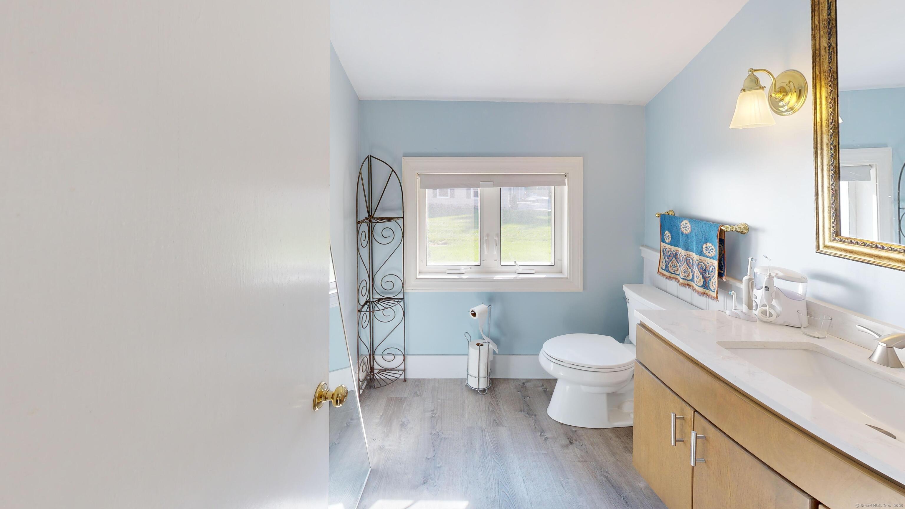 214 Mountain Road Cheshire, CT 06410 - Photo 40 of 40 a bathroom with a granite countertop toilet sink and a window