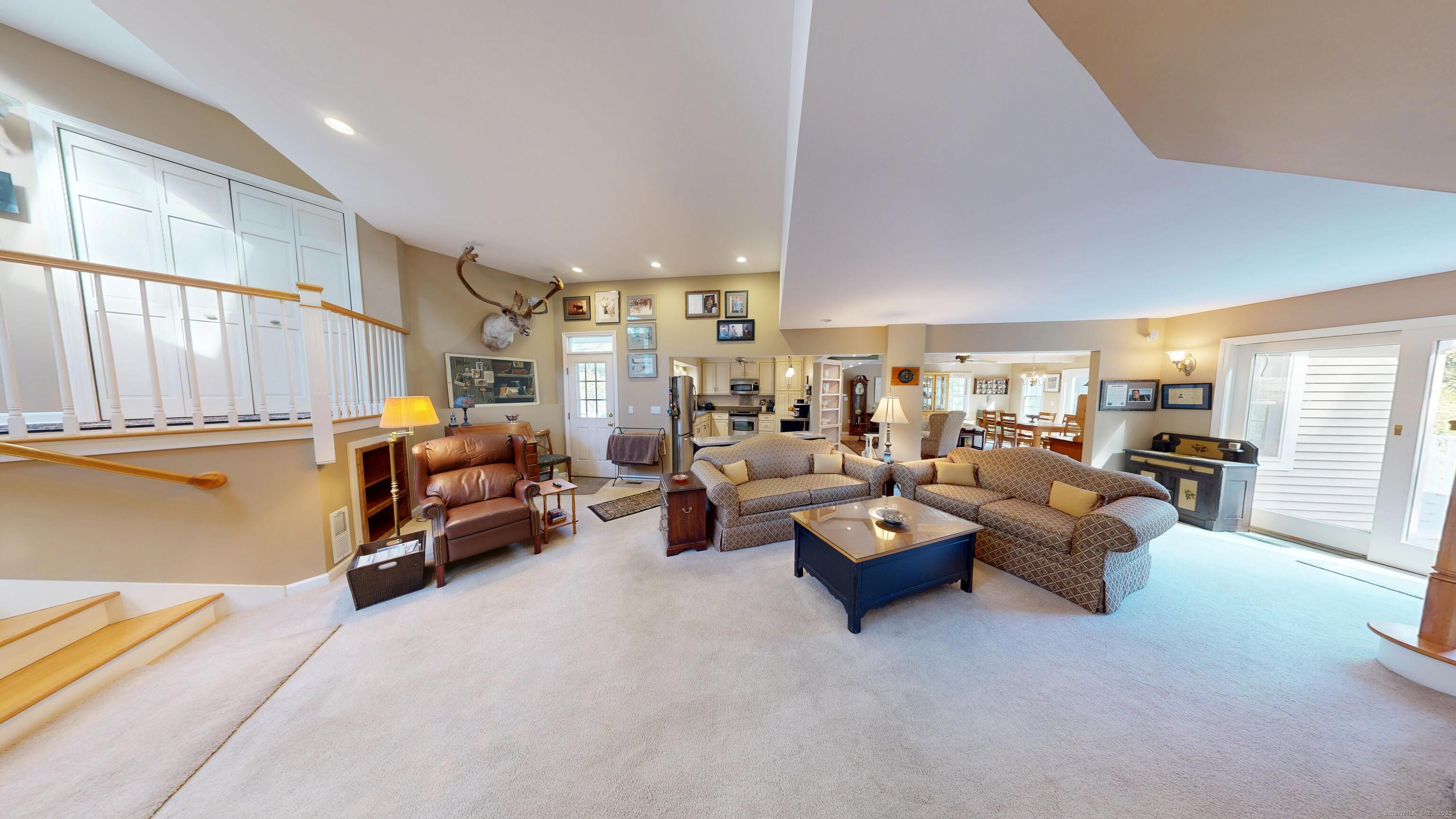 214 Mountain Road Cheshire, CT 06410 - Photo 7 of 40 a living room with couches and a large window with kitchen view