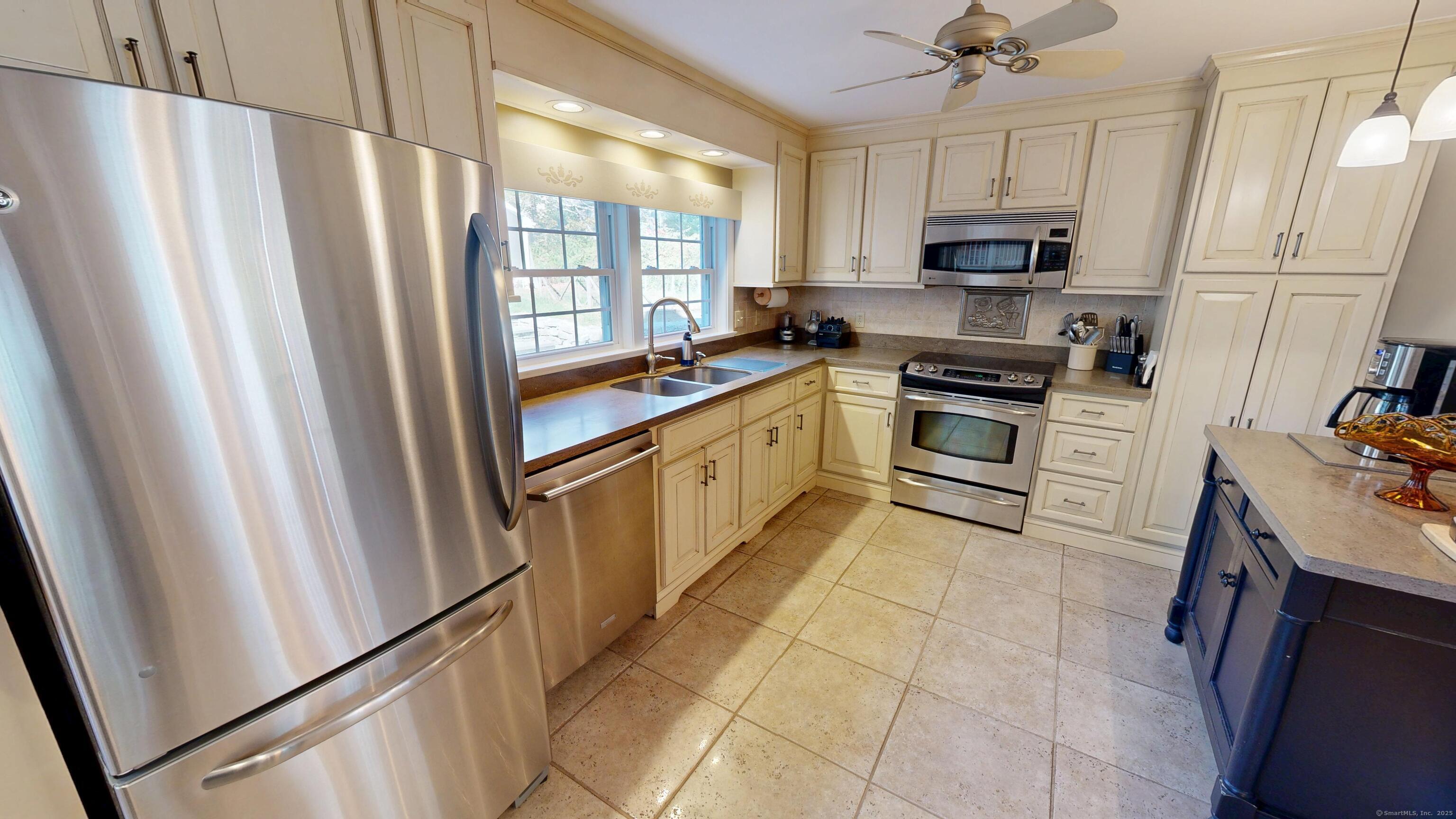 214 Mountain Road Cheshire, CT 06410 - Photo 8 of 40 a kitchen with stainless steel appliances a refrigerator sink and microwave
