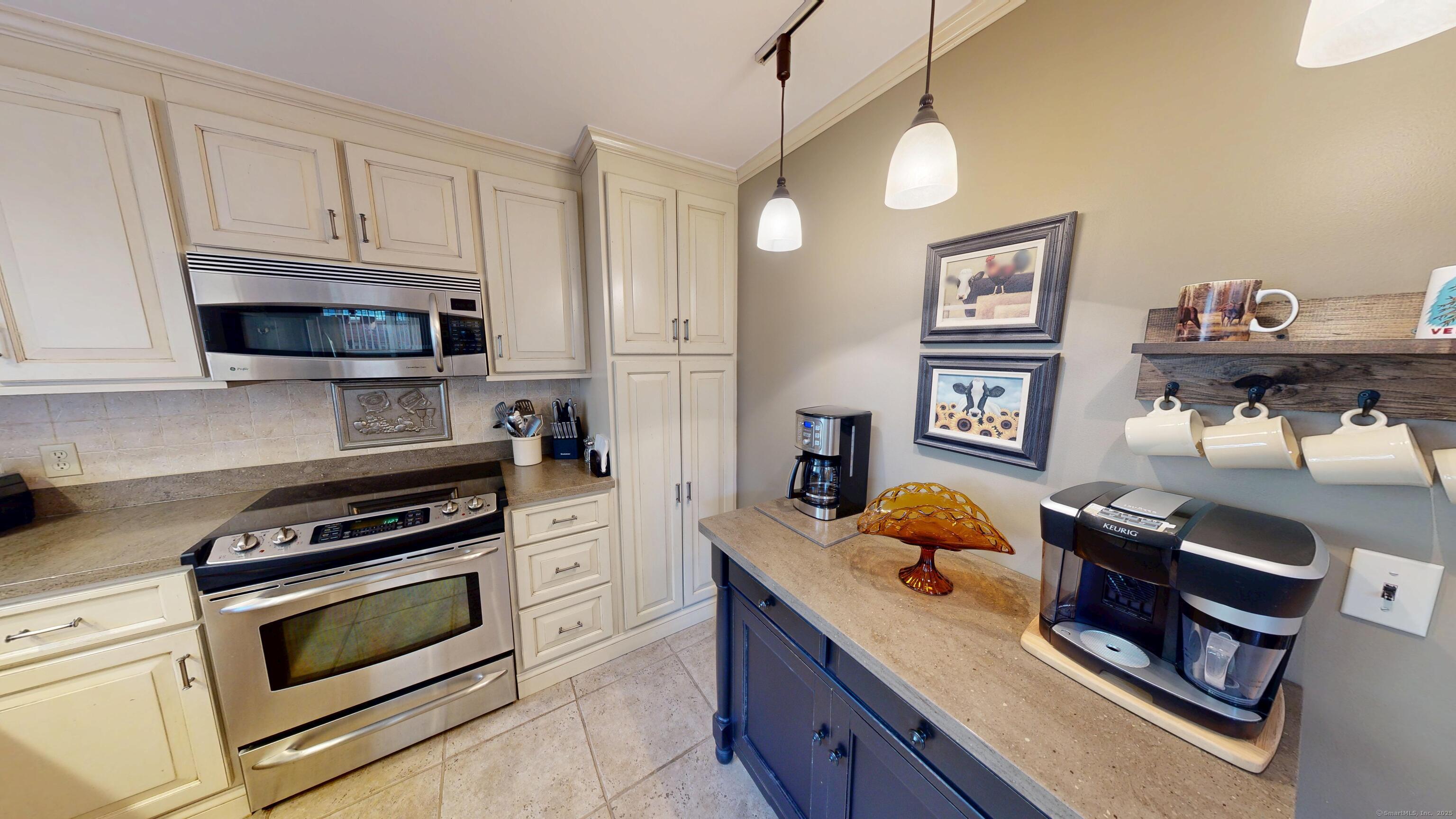214 Mountain Road Cheshire, CT 06410 - Photo 9 of 40 a kitchen with stainless steel appliances granite countertop a stove and cabinets