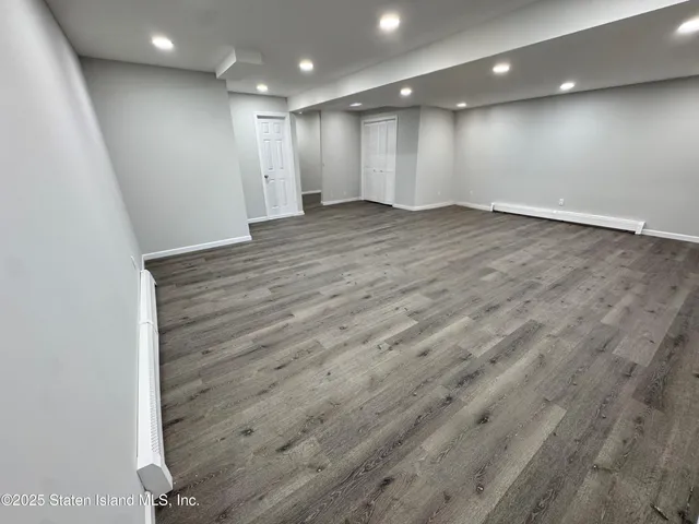 an empty room with wooden floor