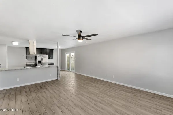 a view of a kitchen with a sink and wooden floor