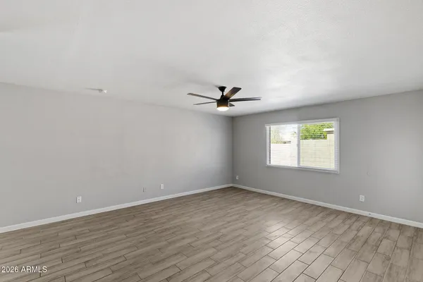 wooden floor in an empty room with a window