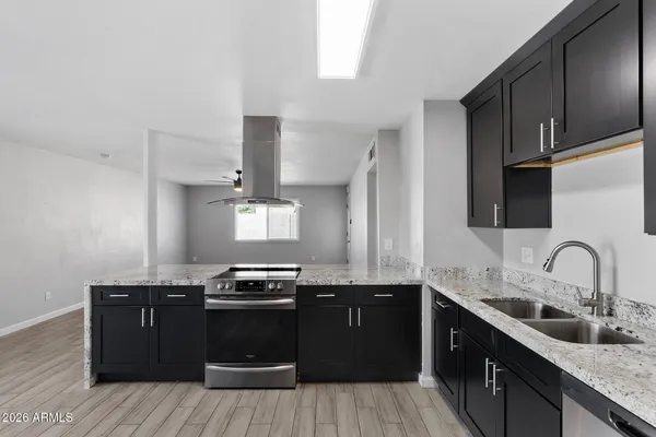 a kitchen with a sink stove and microwave