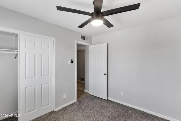an empty room with closet area