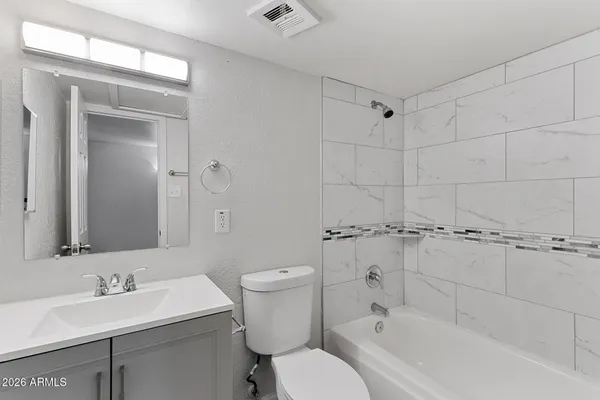 a bathroom with a sink toilet tub and shower