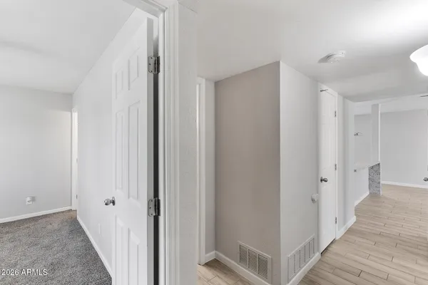 a view of a hallway with wooden floor